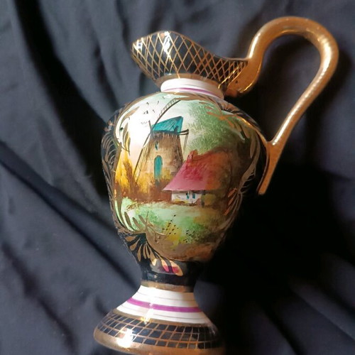 Antique porcelain jug used with hand-painted windmill scene