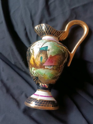 Antique porcelain jug used with hand-painted windmill scene