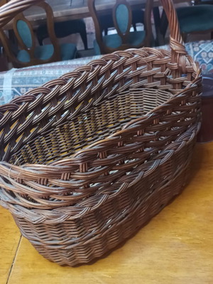 Handmade dark brown wicker basket with high arched handle