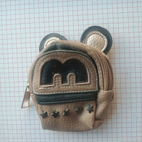 Coin purse used in mini backpack shape with decorative ears and letter M
