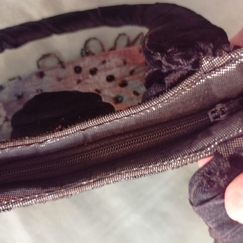 Women's handbag new with metallic silver-gray base and black velvet rosettes