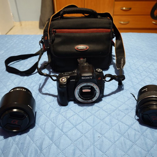 Sony A500 camera used with two lenses, battery, SD card, and carrying case