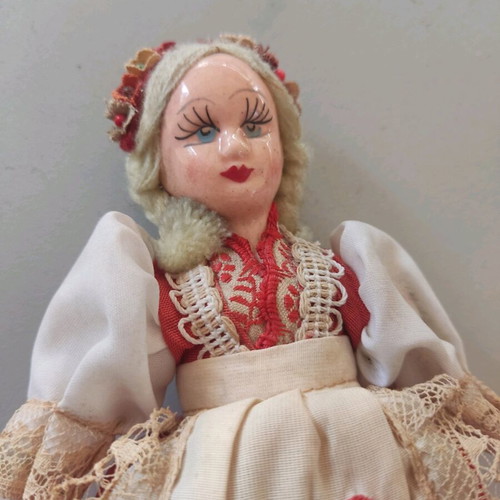 Vintage doll used with porcelain head and embroidered apron