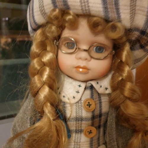 Porcelain dolls new with handmade clothes and support base
