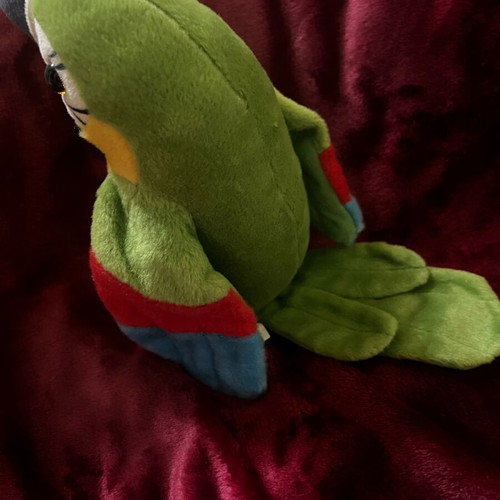 Plush parrot like new that talks and moves its wings