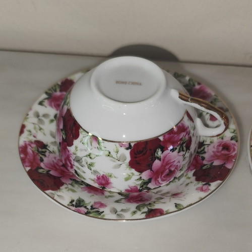 Vintage porcelain tea cups set with floral rose pattern and lithophany