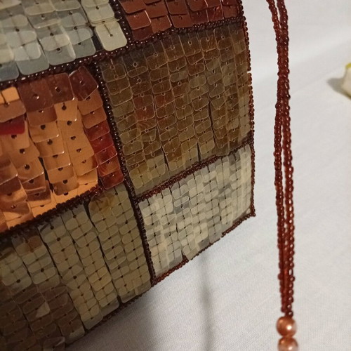 Official hand bag like new in brown shades with sequins