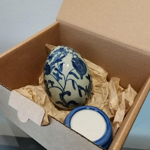 Porcelain egg used with blue designs and stand