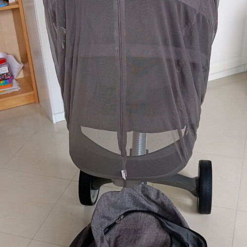 Stokke Xplory stroller used with mosquito net and rain cover