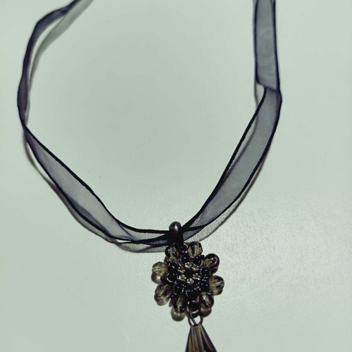 Apefthon necklace new with black transparent ribbon and flower motif