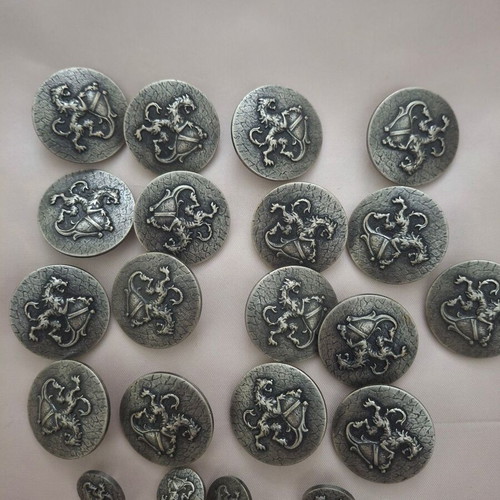 19 silver shield-style clothing buttons with lion design