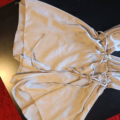 One-piece mini romper like new, gold with crisscross back