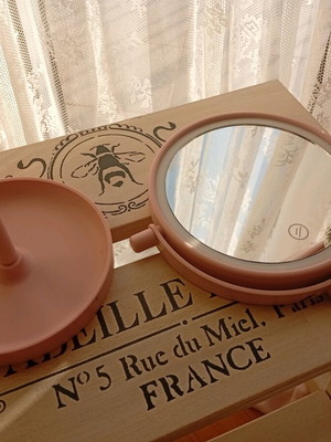 Round pink mirror with stand used