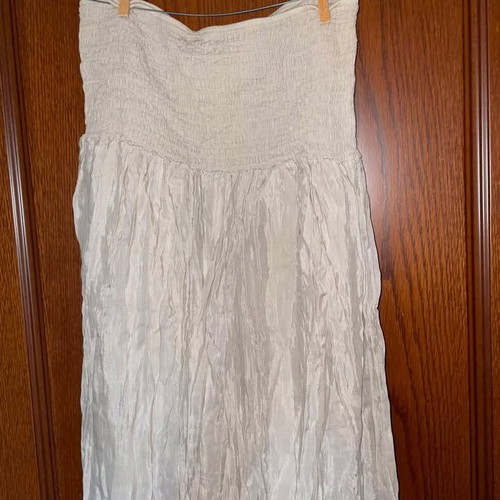 Long beige strapless dress used with honeycomb detail and neck tie