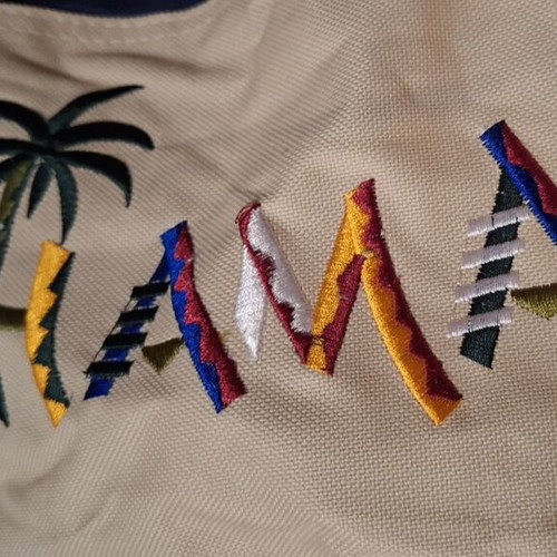 Beige fabric beach bag with colorful embroidered Bahamas lettering