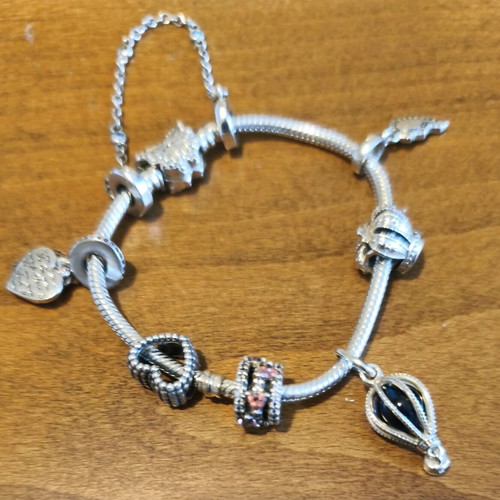Pandora bracelet authentic used size 16 with 6 charms and safety chain
