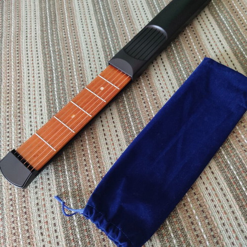 Portable guitar chord trainer with 6 frets and real strings