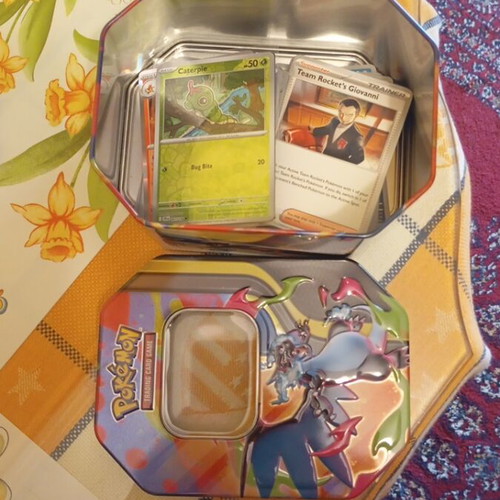 Charizard tin set like new with 50 common, 20 holos and 2 ex Pokémon cards