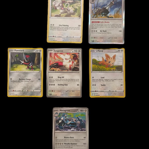 Pokemon trading card collection with Smeargle, Silvally, Pawniard, Zangoose, Lillipup, Metagross