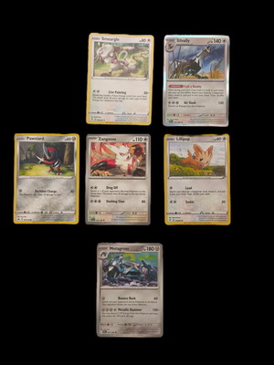 Pokemon trading card collection with Smeargle, Silvally, Pawniard, Zangoose, Lillipup, Metagross