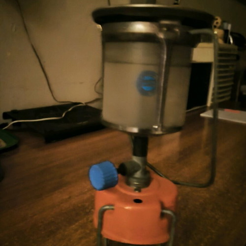 Camping gas lamp used with its protective cage