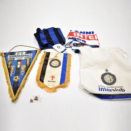 Inter collection with scarves, pennants, cufflinks, magazines and backpack