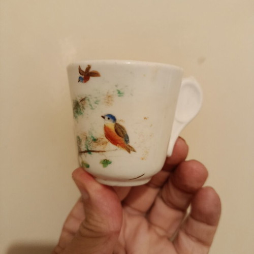 Vintage porcelain cup with bird design