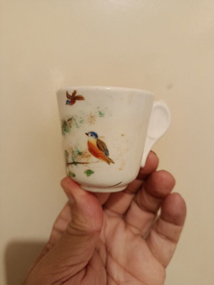 Vintage porcelain cup with bird design