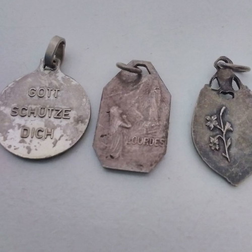 Silver pendant necklace used with zodiac and catholic figures