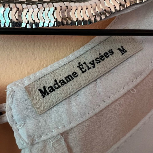 White blouse with silver details around neckline size M like new