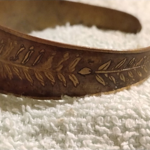 Vintage copper cuff bracelet with Greek neoclassical motifs, used