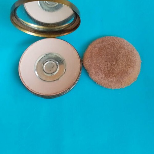 Antique powder compact used with metal bronze casing
