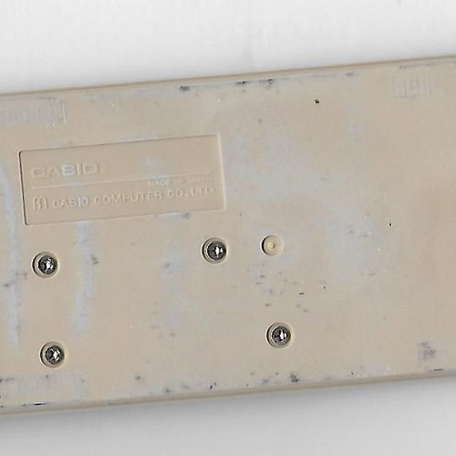 Casio SL-702c solar pocket calculator used with leather case