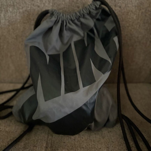 Nike sports backpack with straps and side pocket, black and grey