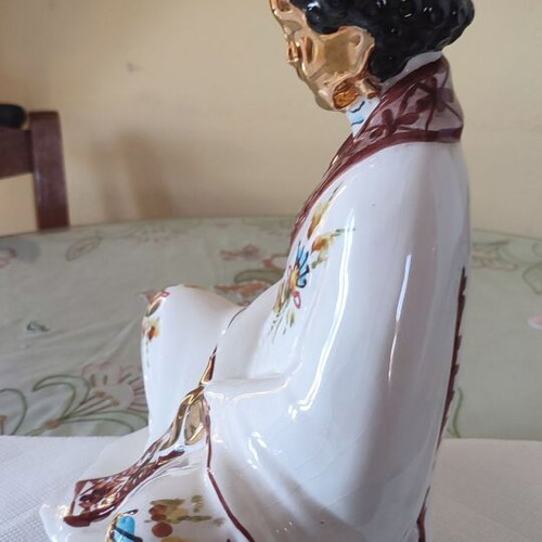 Vintage porcelain Buddha statue with gold details