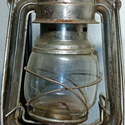 Vintage storm lantern used with cracked glass