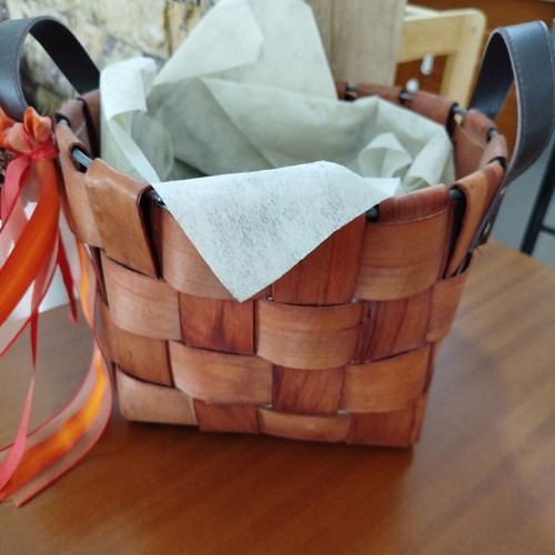 Wooden woven gift basket with leather handles, used