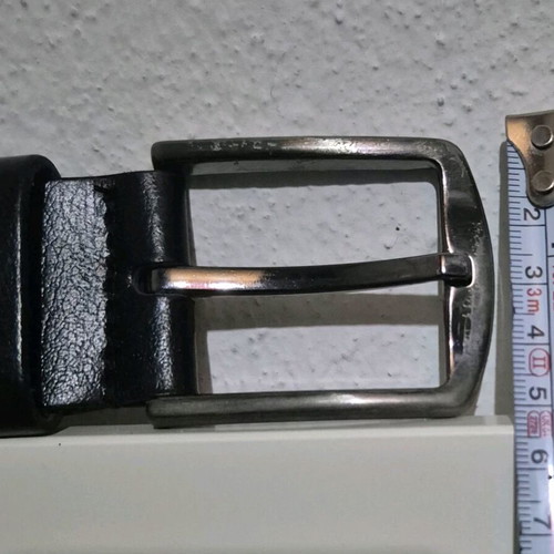 Simple metal belt buckle with prong and leather loop like new