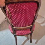 Armchair with carved wood frame and red fabric