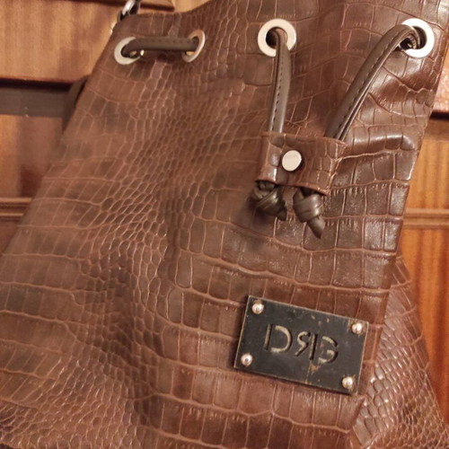 Brown bucket bag with shoulder and crossbody strap