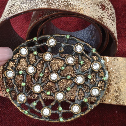 Wide gold belt used with decorative buckle and rhinestones