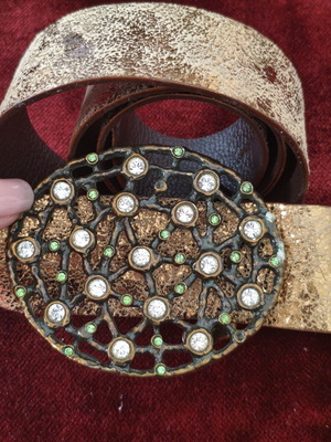Wide gold belt used with decorative buckle and rhinestones