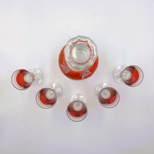 Italian glass decanter with glasses used, red with gold details