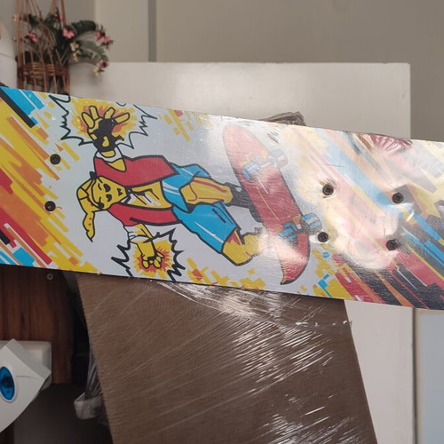 Children's skateboard with colorful comic design, sealed