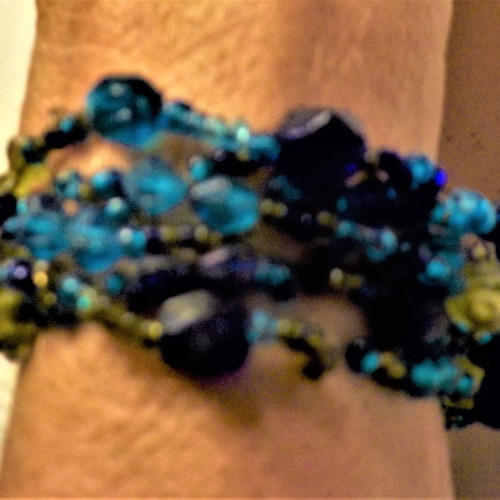 Bracelet with clasp and six rows of blue, light blue, and green beads
