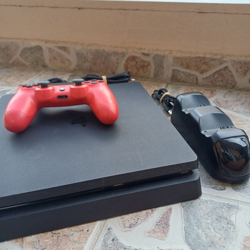 PlayStation 4 Slim 1TB console with red DualShock 4 and charging dock
