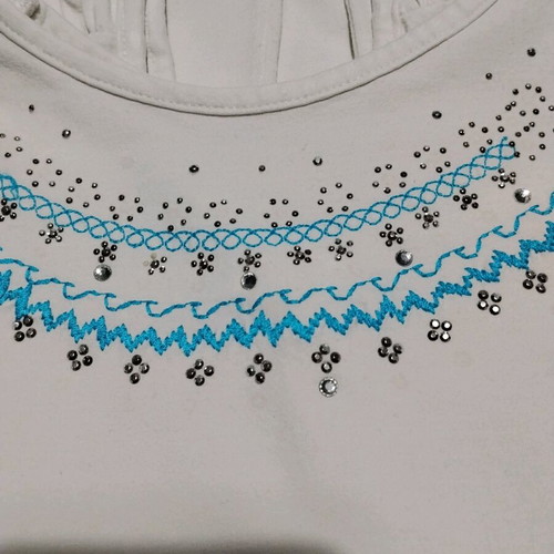 White sleeveless top used with embroidery and rhinestones size M