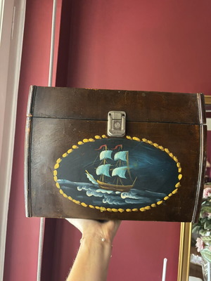 Vintage wooden chest with hand-painted sailboat, used