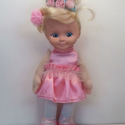Vintage Uneeda doll with pink clothes, blond hair, blue eyes used