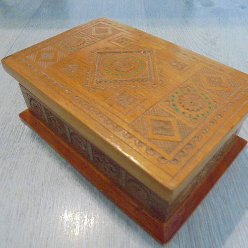 Old wooden carved box with decorative ornaments, used